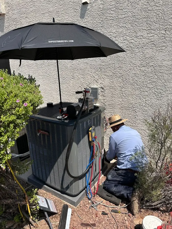 HVAC technician performing outdoor AC maintenance in CaÃ±on City